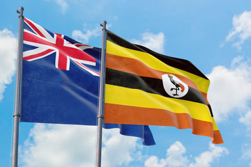 Uganda and Anguilla flags waving in the wind against white cloudy blue sky together. Diplomacy concept, international relations.