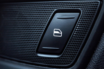 car interior details of door handle with windows controls and adjustments. Car window controls and details