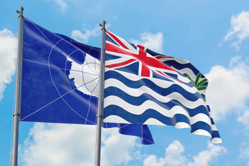 British Indian Ocean Territory and Antarctica flags waving in the wind against white cloudy blue sky together. Diplomacy concept, international relations.
