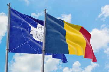 Chad and Antarctica flags waving in the wind against white cloudy blue sky together. Diplomacy concept, international relations.