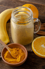 Healthy smoothie with turmeric and orangeg banana and