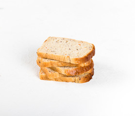 Whole grain fitness bread with dried carrots and flax, pumpkin, and sunflower seeds, sliced on a light background