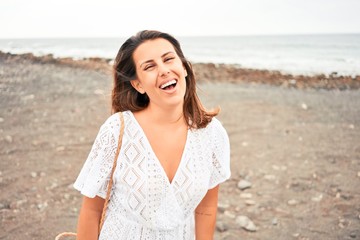 Young beautiful woman smiling happy enjoying summer vacation at black sand beach at Canary Islands