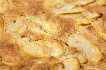 Apple pie, dessert from stewed fruits, closeup, texture, background. Charlotte, homemade baking