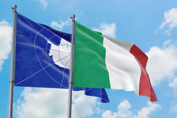 Italy and Antarctica flags waving in the wind against white cloudy blue sky together. Diplomacy concept, international relations.