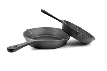 Cast iron pans isolated on white background. Two black empty skillets. Kitchen equipment, cookware