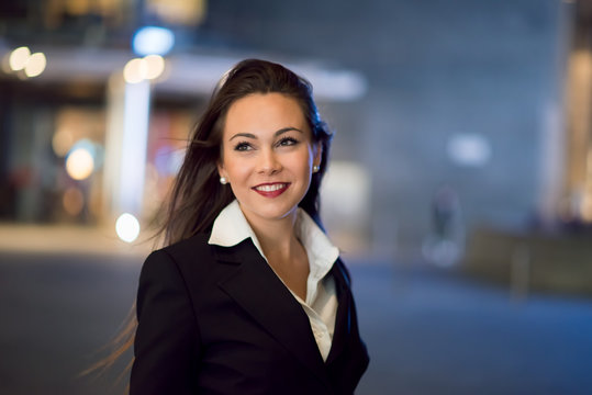 Young business woman portrait at night in a city
