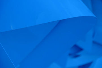 Blue abstract background of intersecting material planes. Close-up