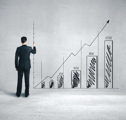 Businessman drawing business chart