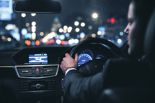 Businessman Driving Car At Night