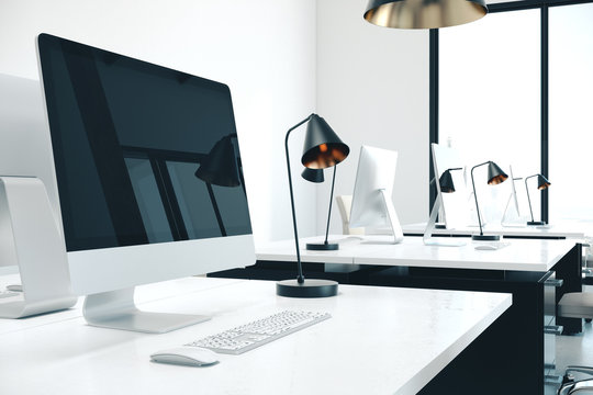 Designer desktop with empty computer screen