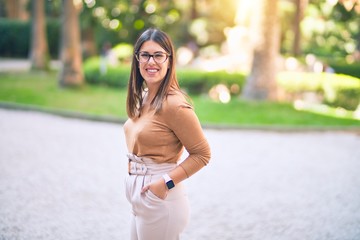 Young beautiful woman smiling happy and confident. Standing with smile on face at the town street