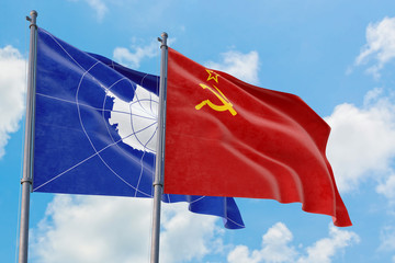 Soviet Union and Antarctica flags waving in the wind against white cloudy blue sky together. Diplomacy concept, international relations.