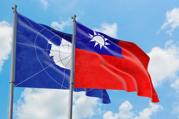 Taiwan and Antarctica flags waving in the wind against white cloudy blue sky together. Diplomacy concept, international relations.
