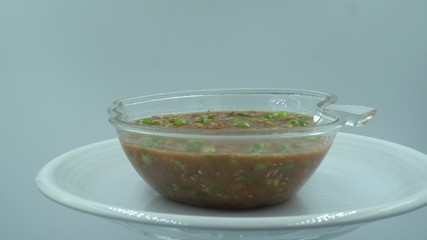 Chili paste in white background. Thai food to eat with boiled vegetables.