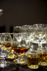 a glass of wine and a glass of whiskey stands on the table