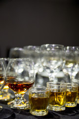 a glass of wine and a glass of whiskey stands on the table