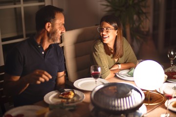 Handsome father and beautiful daughter dinning and smiling at terrace