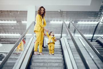 Beautiful girl in a shopping center. Lady with shopping bags. Mother with daughter in stylish clothes