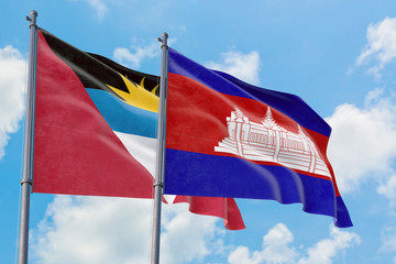 Cambodia and Antigua and Barbuda flags waving in the wind against white cloudy blue sky together. Diplomacy concept, international relations.