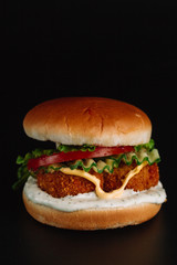Big hamburger, chicken nuggets On black background