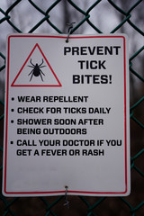 Sign warning about ticks and tick bites. Prevention measures