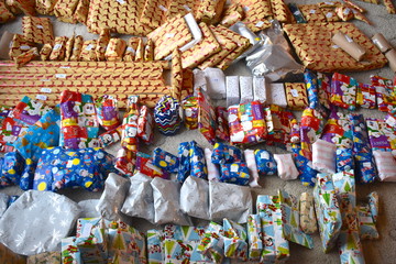 Closeup of a large stack of colorful wrapped Christmas presents of varying sizes and shapes Pile of festive gifts Smaller surprise items in traditional paper before larger mystery objects in the rear