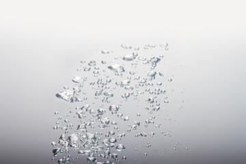 Beautiful gray water waves splashing in clean water on the gray background