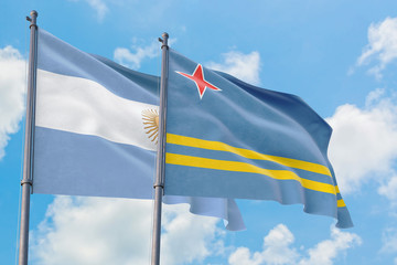 Aruba and Argentina flags waving in the wind against white cloudy blue sky together. Diplomacy concept, international relations.