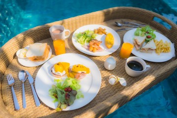 Floating breakfast around outdoor swimming pool