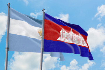 Cambodia and Argentina flags waving in the wind against white cloudy blue sky together. Diplomacy concept, international relations.