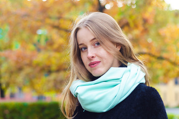 Portrait of a young beautiful red-haired girl with freckles on an autumn background. correction bite for woman. happy mysterious lady with braces.