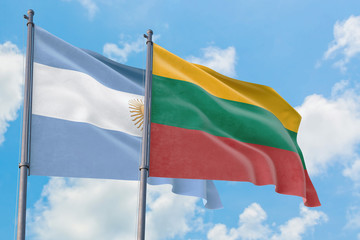 Lithuania and Argentina flags waving in the wind against white cloudy blue sky together. Diplomacy concept, international relations.