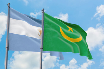 Mauritania and Argentina flags waving in the wind against white cloudy blue sky together. Diplomacy concept, international relations.