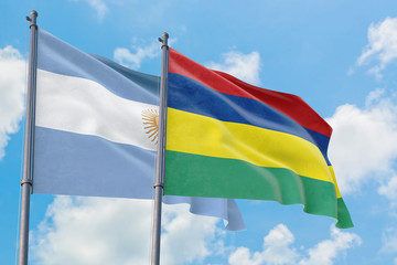 Mauritius and Argentina flags waving in the wind against white cloudy blue sky together. Diplomacy concept, international relations.