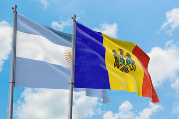 Moldova and Argentina flags waving in the wind against white cloudy blue sky together. Diplomacy concept, international relations.