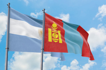 Mongolia and Argentina flags waving in the wind against white cloudy blue sky together. Diplomacy concept, international relations.