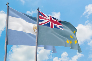 Tuvalu and Argentina flags waving in the wind against white cloudy blue sky together. Diplomacy...