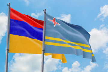 Aruba and Armenia flags waving in the wind against white cloudy blue sky together. Diplomacy concept, international relations.