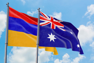 Fototapeta premium Australia and Armenia flags waving in the wind against white cloudy blue sky together. Diplomacy concept, international relations.