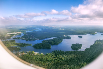 Aerial view of Brandenburg lakes and forests from the airplane window, Germany
