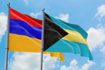 Bahamas and Armenia flags waving in the wind against white cloudy blue sky together. Diplomacy concept, international relations.