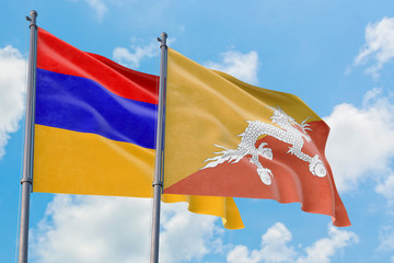 Bhutan and Armenia flags waving in the wind against white cloudy blue sky together. Diplomacy concept, international relations.