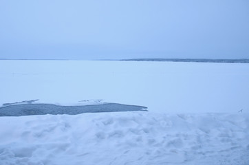 traditional Kaupinojan Sauna next to the lake Nasijarvi with Hole in the Ice.