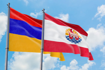 Fototapeta na wymiar French Polynesia and Armenia flags waving in the wind against white cloudy blue sky together. Diplomacy concept, international relations.