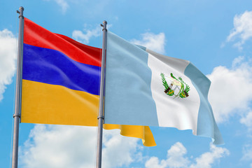Guatemala and Armenia flags waving in the wind against white cloudy blue sky together. Diplomacy concept, international relations.