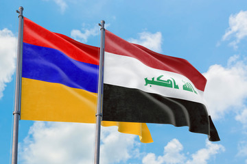 Iraq and Armenia flags waving in the wind against white cloudy blue sky together. Diplomacy concept, international relations.