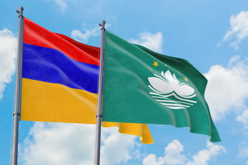 Macao and Armenia flags waving in the wind against white cloudy blue sky together. Diplomacy concept, international relations.