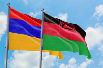 Malawi and Armenia flags waving in the wind against white cloudy blue sky together. Diplomacy concept, international relations.