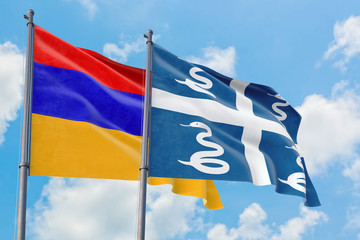 Martinique and Armenia flags waving in the wind against white cloudy blue sky together. Diplomacy concept, international relations.
